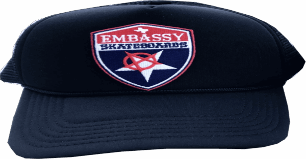embassy shield logo on black trucker cap